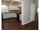Well-lit kitchen features white cabinets, dark appliances, wood-look flooring and warm paint at 2502 N Harding St, Indianapolis, IN 46208