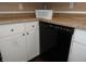 A modern black dishwasher is framed by white cabinets and unique granite countertops at 2502 N Harding St, Indianapolis, IN 46208