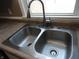 Close-up of a clean, double-bowl stainless steel sink with a modern faucet fixture at 2502 N Harding St, Indianapolis, IN 46208