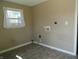 Well-lit laundry room with vinyl flooring and hookups for a washer and dryer at 2502 N Harding St, Indianapolis, IN 46208