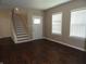 Inviting living room featuring hardwood floors, natural light, and staircase at 2502 N Harding St, Indianapolis, IN 46208