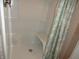 Bright white shower with seating and a stylish seashell pattern shower curtain at 2502 N Harding St, Indianapolis, IN 46208