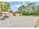Large backyard with concrete, a detached garage, and plenty of trees at 2823 Tulip Dr, Indianapolis, IN 46227