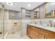 Modern bathroom featuring a double vanity with marble countertop and a frameless glass shower with gold fixtures at 2823 Tulip Dr, Indianapolis, IN 46227