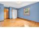 Bedroom with hardwood floors, a window, closet, and blue walls at 2823 Tulip Dr, Indianapolis, IN 46227