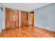 Bedroom featuring hardwood floors, light blue walls, and closet doors with decorative lattice design at 2823 Tulip Dr, Indianapolis, IN 46227