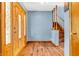 Welcoming entryway showcases a stained wood front door, staircase, wood floors, and blue-grey painted walls at 2823 Tulip Dr, Indianapolis, IN 46227