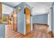 Hallway featuring wood floors, doors, and trim that leads into the living room, dining room and kitchen at 2823 Tulip Dr, Indianapolis, IN 46227