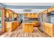Open kitchen featuring stainless steel appliances, a center island, and wood cabinetry at 2823 Tulip Dr, Indianapolis, IN 46227