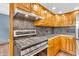 Modern kitchen with a stainless steel range, wood cabinets and tiled backsplash at 2823 Tulip Dr, Indianapolis, IN 46227
