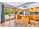Spacious kitchen features stainless appliances, hardwood floors, and backyard access through sliding glass doors at 2823 Tulip Dr, Indianapolis, IN 46227