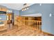 Open living room leading to a kitchen featuring wood-look floors and a staircase to the second level at 2823 Tulip Dr, Indianapolis, IN 46227