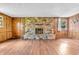 Spacious living room showcasing a stone fireplace, wood-look flooring, and natural lighting at 2823 Tulip Dr, Indianapolis, IN 46227