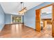 Bright living room features an ornate light fixture, hardwood floors, and a view into the kitchen at 2823 Tulip Dr, Indianapolis, IN 46227