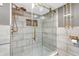 Elegant walk-in shower with glass door, rain shower head, and tiled walls with gold fixtures at 2823 Tulip Dr, Indianapolis, IN 46227