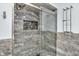 Modern shower featuring marble tile, glass door, niche, and modern fixtures at 2823 Tulip Dr, Indianapolis, IN 46227