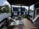 Back deck with outdoor seating and a view of the backyard, patio, and neighboring homes at 3054 Ruckle St, Indianapolis, IN 46205