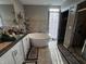 Luxurious bathroom featuring a soaking tub, dual vanities, and a separate shower at 3054 Ruckle St, Indianapolis, IN 46205