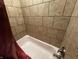 Close up of a tiled bathtub and faucet fixture at 3054 Ruckle St, Indianapolis, IN 46205