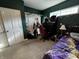 A bedroom features dark green walls, a desk with guitars, and a window with hanging vines at 3054 Ruckle St, Indianapolis, IN 46205
