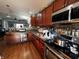 Bright kitchen with stainless steel appliances, wood cabinets, tile backsplash, and hardwood floors at 3054 Ruckle St, Indianapolis, IN 46205