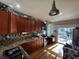 Features include wood cabinets, granite countertops, stainless steel appliances, and a side entrance to the deck at 3054 Ruckle St, Indianapolis, IN 46205