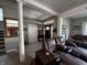 Comfortable living room with a brown reclining sofa, a large mirror, and a view of the front entry at 3054 Ruckle St, Indianapolis, IN 46205