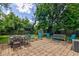 Spacious backyard patio, ideal for outdoor dining and entertaining with furniture and shed at 315 W 43Rd St, Indianapolis, IN 46208
