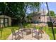 A backyard featuring a fire pit surrounded by chairs at 315 W 43Rd St, Indianapolis, IN 46208