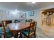 Basement dining area featuring a wooden table with chairs and access to utilities room at 315 W 43Rd St, Indianapolis, IN 46208
