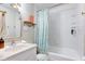 Bright bathroom with white tiles, floral shower curtain, and classic fixtures at 315 W 43Rd St, Indianapolis, IN 46208
