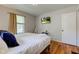 Bedroom with hardwood floors, neutral walls, and a flatscreen television mounted on the wall at 315 W 43Rd St, Indianapolis, IN 46208