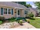 Charming home's front porch with green trim, white awning, and landscaped garden beds at 315 W 43Rd St, Indianapolis, IN 46208