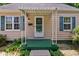 Quaint front porch with a stylish awning, decorative columns, and vibrant green accents at 315 W 43Rd St, Indianapolis, IN 46208
