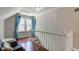 Hallway with hardwood floors, natural light, and white banister at 315 W 43Rd St, Indianapolis, IN 46208