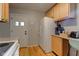 Spacious kitchen with wood cabinets, appliances, and an exterior door at 315 W 43Rd St, Indianapolis, IN 46208