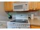 Close-up of an oven and a microwave with wood cabinets at 315 W 43Rd St, Indianapolis, IN 46208