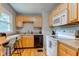 Bright kitchen featuring wood cabinets and modern appliances with a window view at 315 W 43Rd St, Indianapolis, IN 46208
