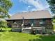 Brick home featuring a wooden deck with outdoor furniture and a lush lawn at 3418 S Rosewind Dr, New Palestine, IN 46163