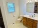 Bright bathroom features a window, a vanity with sink and a toilet at 3418 S Rosewind Dr, New Palestine, IN 46163