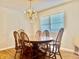 Elegant dining room featuring a crystal chandelier and traditional wood table with chairs at 3418 S Rosewind Dr, New Palestine, IN 46163