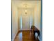 Inviting foyer featuring hardwood floors, a chandelier, and a console table at 3418 S Rosewind Dr, New Palestine, IN 46163