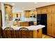 Spacious eat-in kitchen featuring oak cabinets, sleek black appliances, and counter seating for two at 3418 S Rosewind Dr, New Palestine, IN 46163