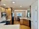 Spacious kitchen with oak cabinets, black appliances, with an adjacent dining area at 3418 S Rosewind Dr, New Palestine, IN 46163