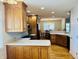 The kitchen boasts oak cabinetry, white countertops, and seamlessly connects to the dining area at 3418 S Rosewind Dr, New Palestine, IN 46163