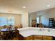 Bright eat-in kitchen features oak cabinets, white countertops, and seamlessly connects to the dining area at 3418 S Rosewind Dr, New Palestine, IN 46163