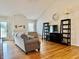 Cozy living room with high ceilings, hardwood floors, and a decorative fireplace at 3418 S Rosewind Dr, New Palestine, IN 46163