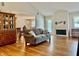 Inviting living room with hardwood floors, fireplace, and view into the elegant dining area at 3418 S Rosewind Dr, New Palestine, IN 46163