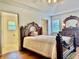 Traditional main bedroom with ensuite bath, wood floors, and abundant natural light at 3418 S Rosewind Dr, New Palestine, IN 46163