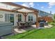 Inviting back patio featuring an outdoor kitchen, comfortable seating under a pergola, and a hot tub for stylish relaxation at 3420 Stoddard Pl, Indianapolis, IN 46217